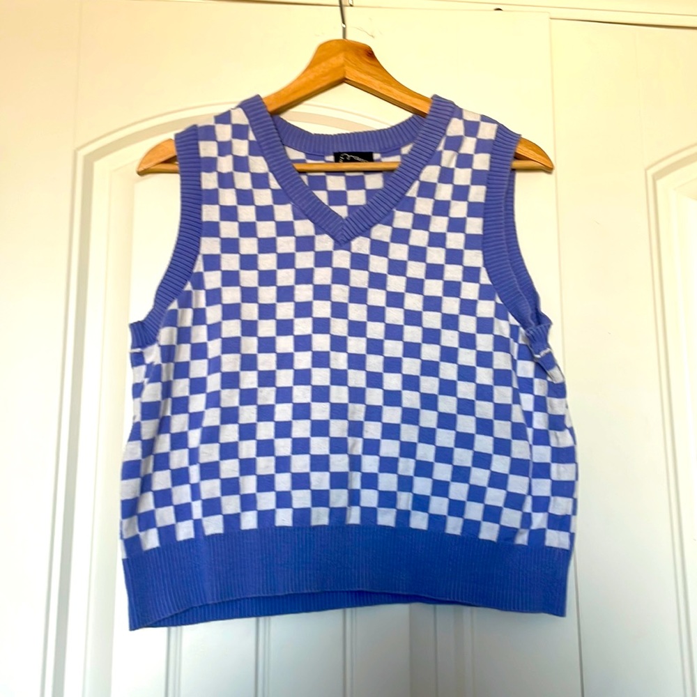 A purple sweater vest it is an XXL in kid the brand is Art Class